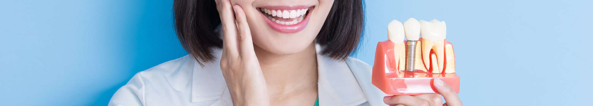 woman dentist taking implant tooth