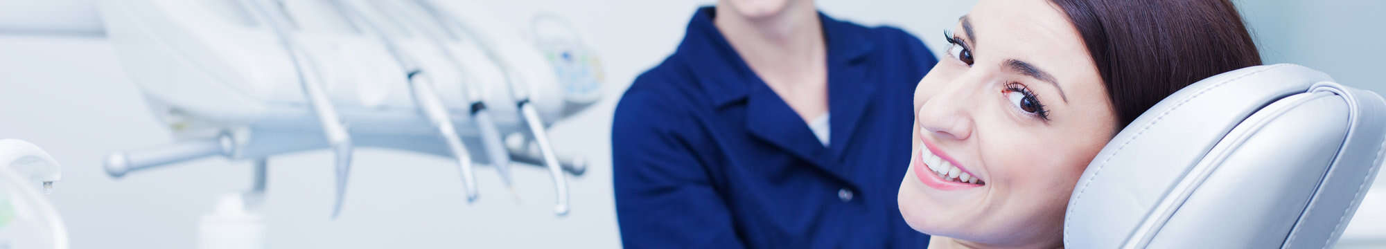 a woman smiling for the camera while having a dental check up